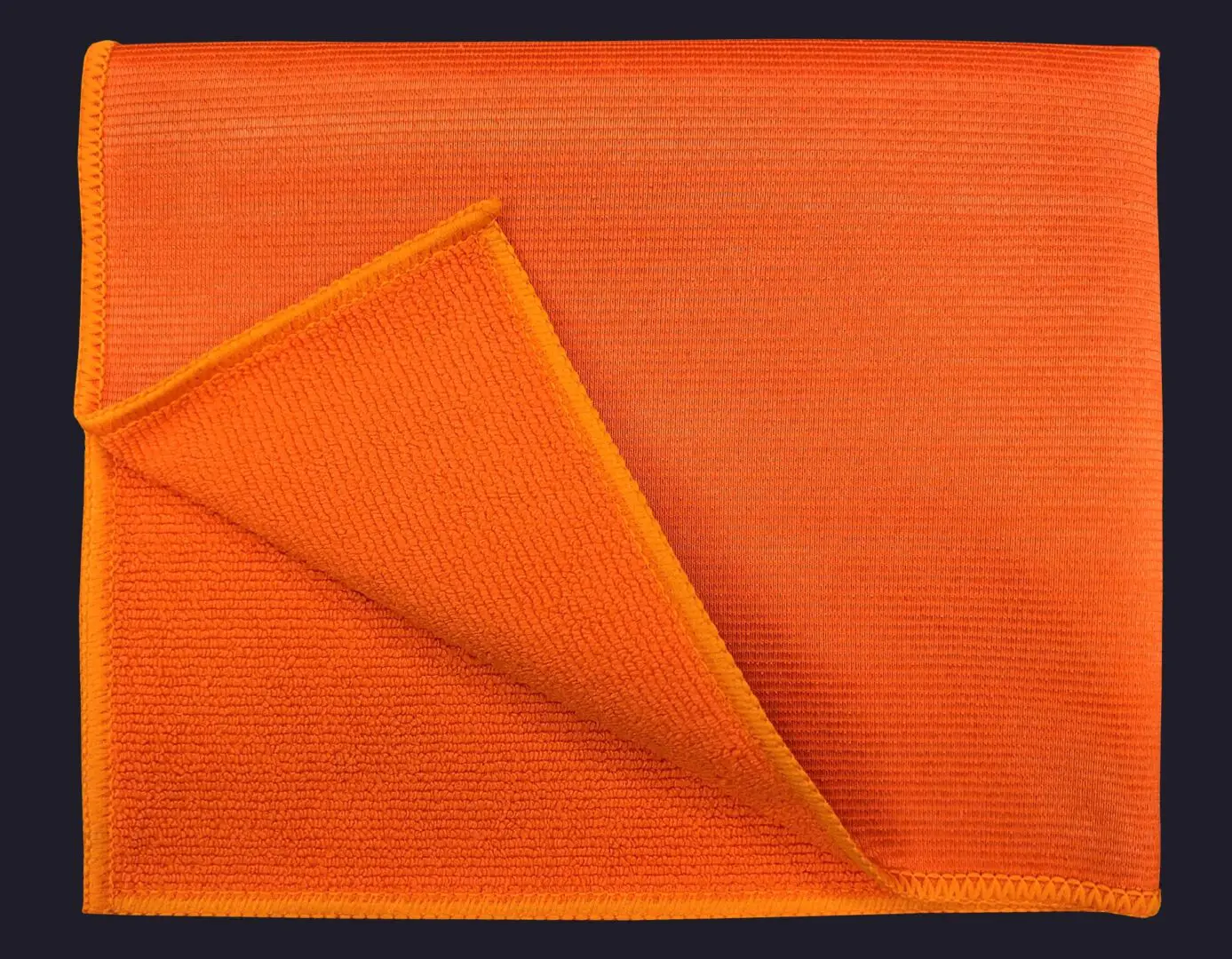 Orange color cloth folded on navy blue background