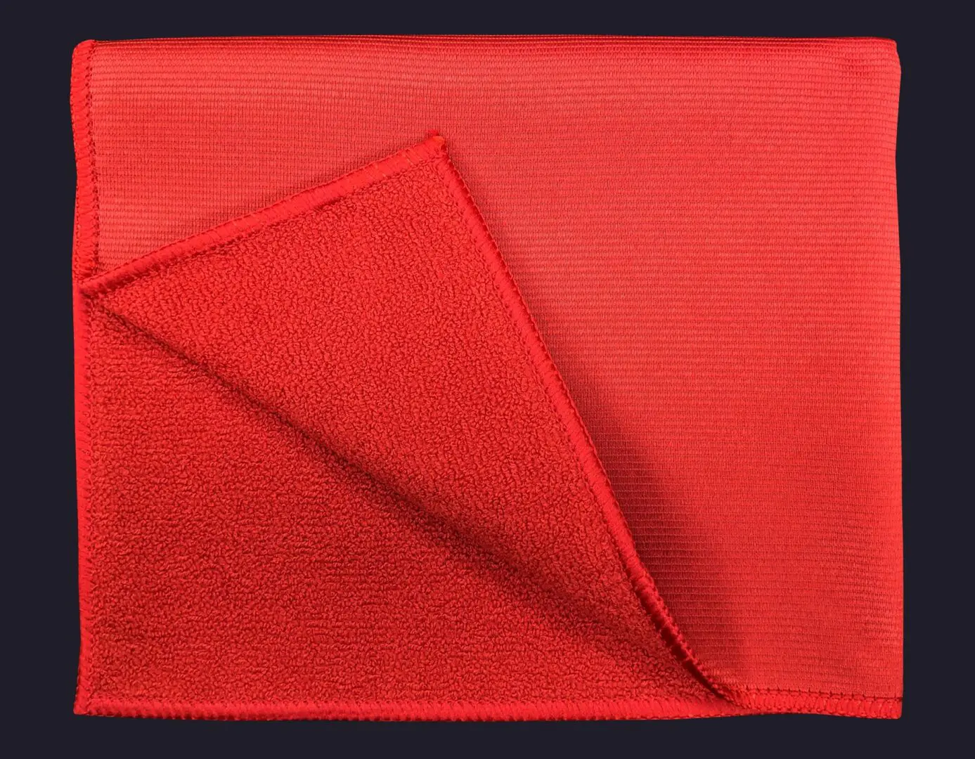 Red color cloth folded on navy blue background