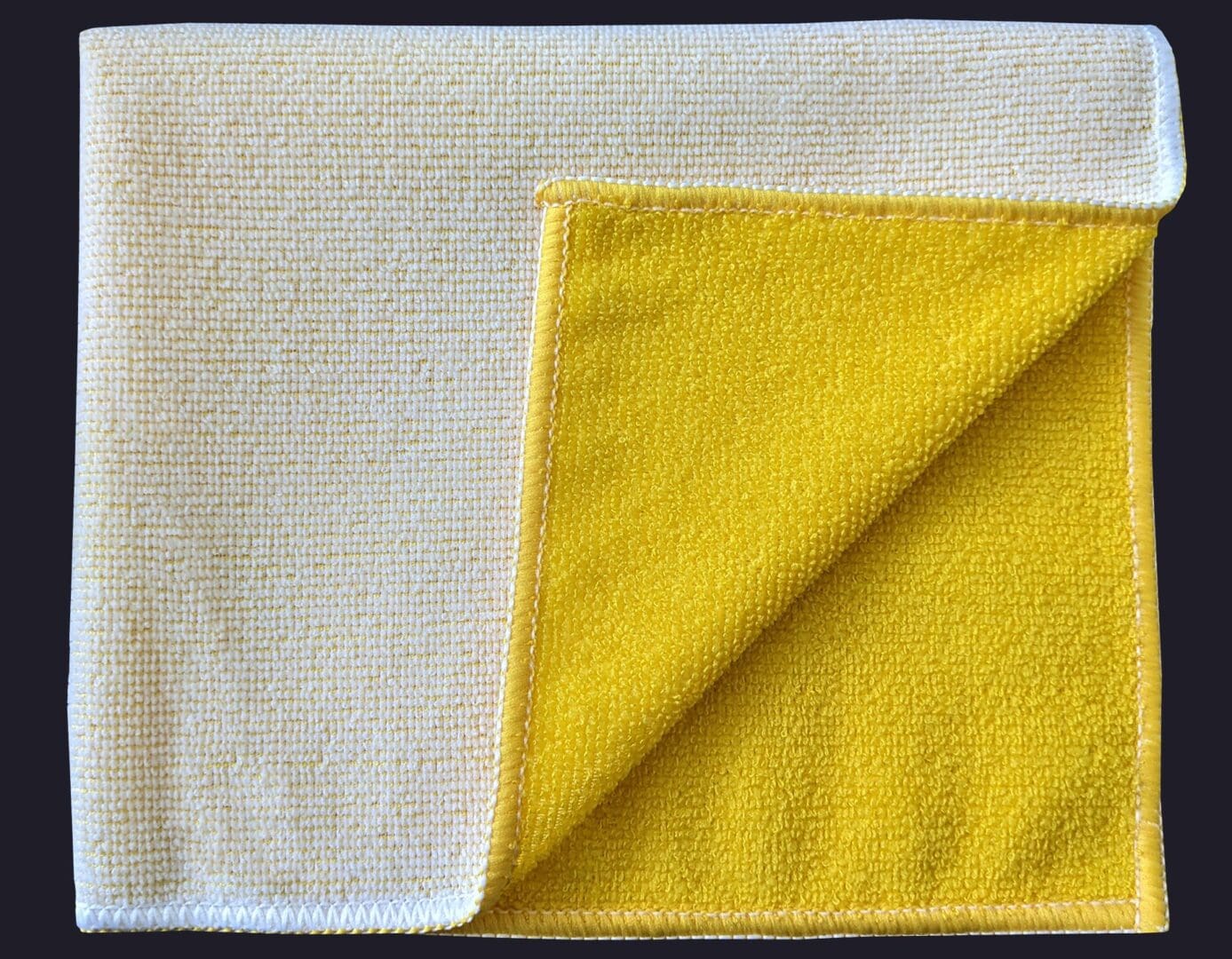 Yellow color cloth folded on black background