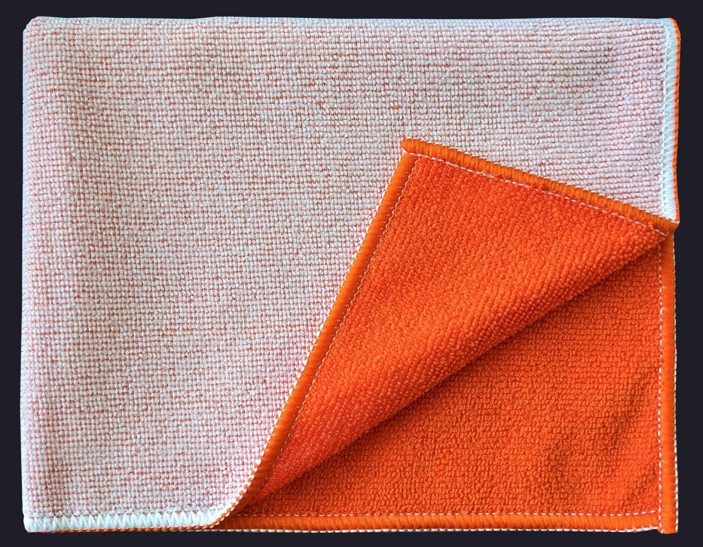 Orange color cloth folded in on black background