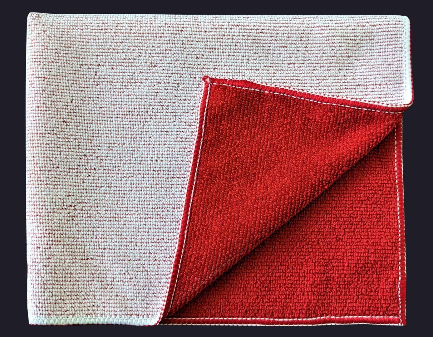 Red color cloth folded in on black background
